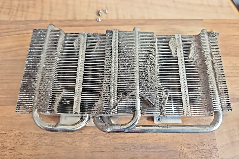 Dust-blocked graphics card heatsink removed for fault and overheating diagnosis in Birmingham