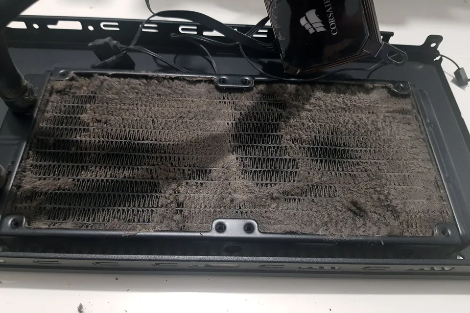 Dust-blocked PC radiator removed during an overheating diagnosis in Birmingham